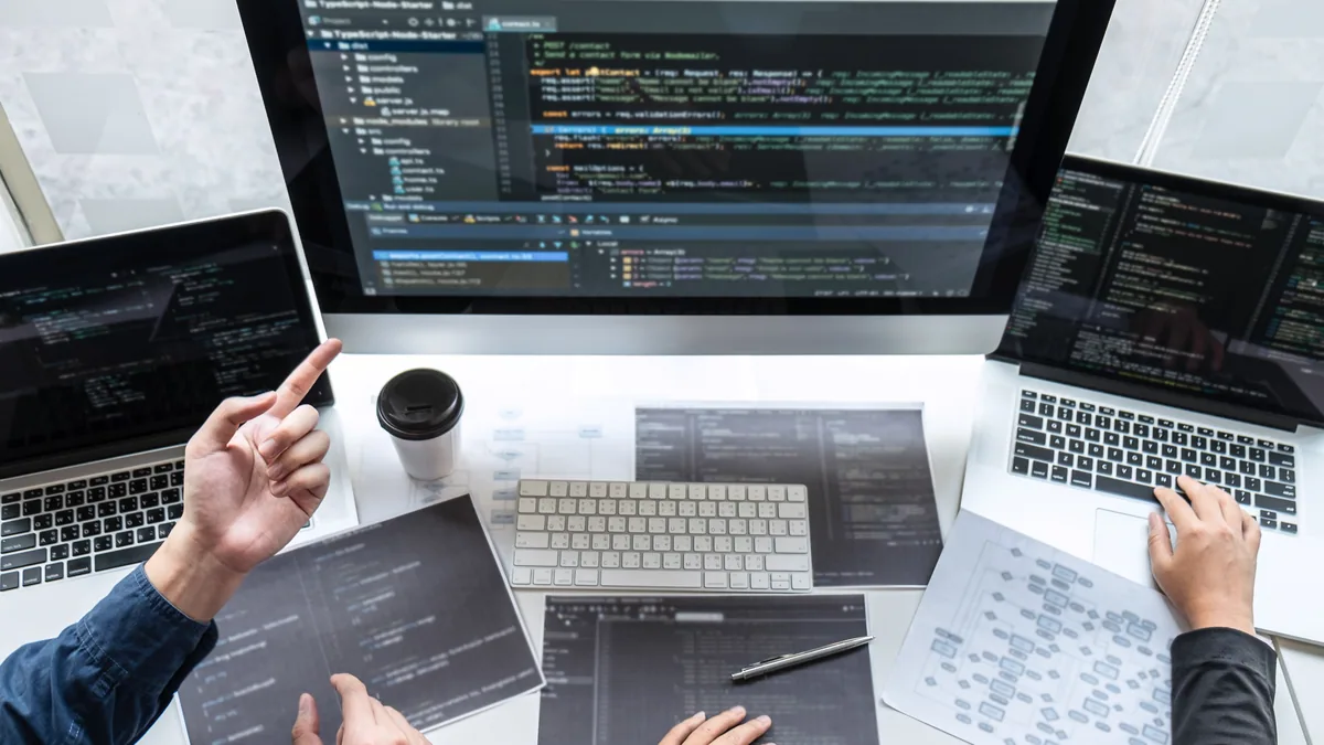 Computer programmers develop code on multiple comp